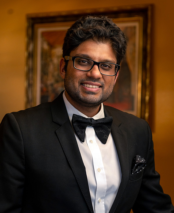 2026 portrait of Dr. Ravi Viradia wearing a suit and bow tie. Viradia Plastic Surgery in Tampa, Florida.