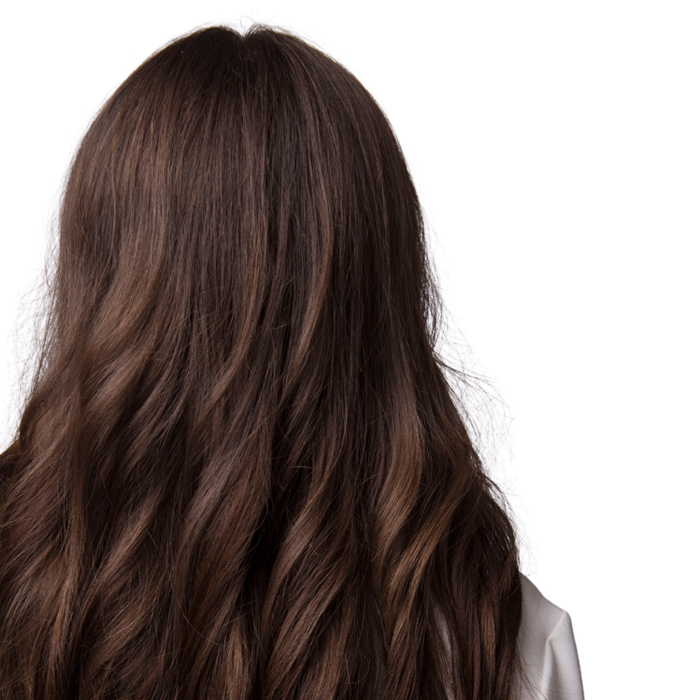 Woman stands with her back to the camera, long flowing hair in the shot.